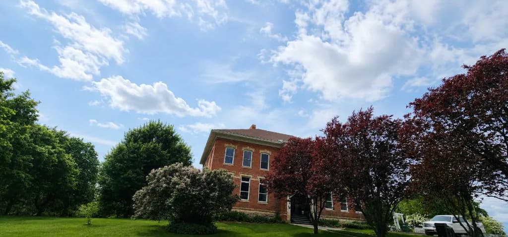 The historic red-brick schoolhouse at 515 North Main Street in Latah, WA — ImpactMe.AI headquarters